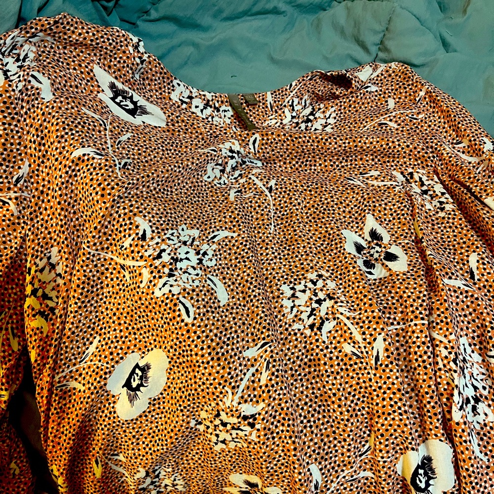 Brina &EM size XXL fits like an XL. Mainly orange with blue and white.